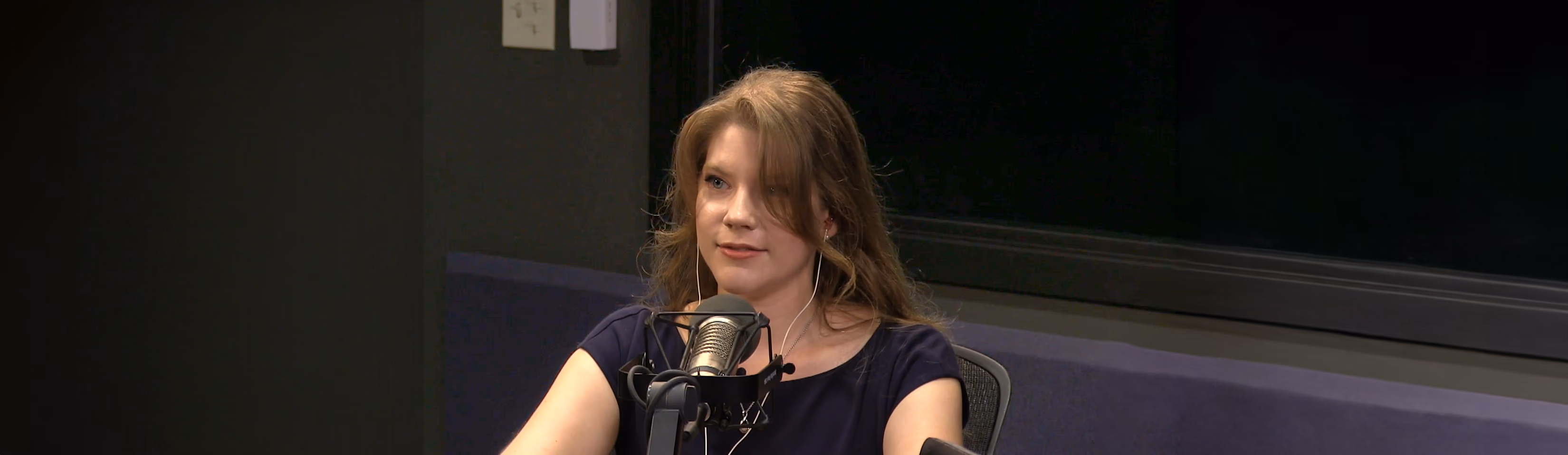 Lea Patterson speaking into a microphone